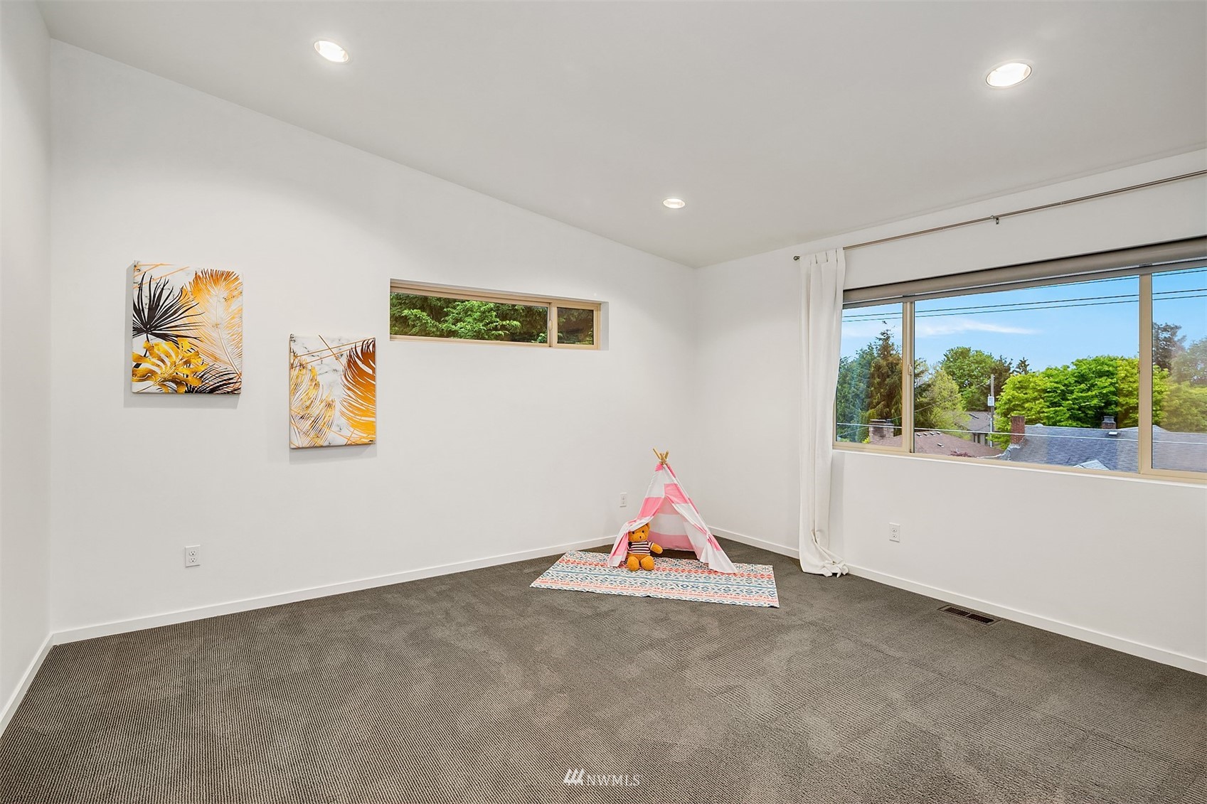 8000 Meridian Avenue North Seattle, WA 98103 - Photo 22 of 33 a view of a room with gym equipment and a large window