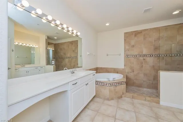 a spacious bathroom with a granite countertop sink a toilet a mirror and shower
