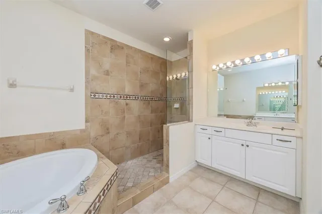 a bathroom with a granite countertop sink a toilet and bathtub