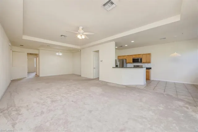 a view of a kitchen with a sink and a refrigerator