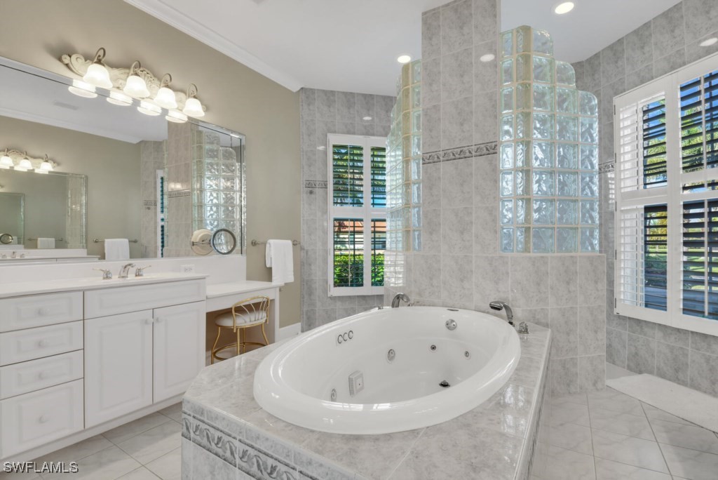 2810 Southwest 49th Terrace Cape Coral, FL 33914 - Photo 15 of 33 a bathroom with a tub a sink shower and mirror