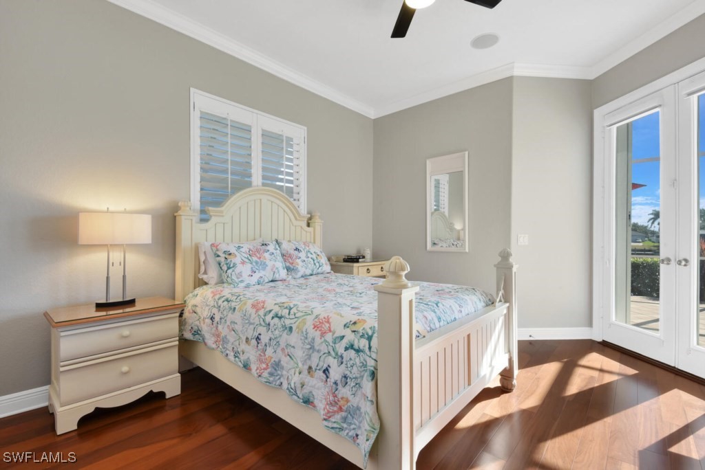 2810 Southwest 49th Terrace Cape Coral, FL 33914 - Photo 18 of 33 a bedroom with a bed and a chandelier