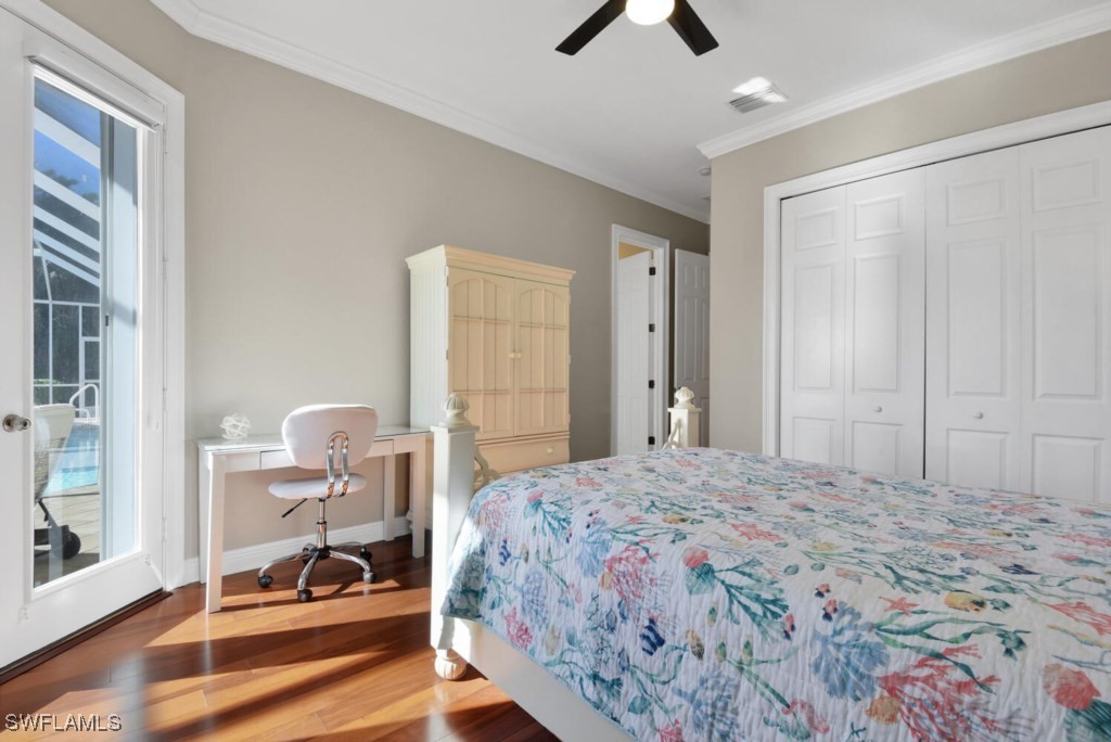 2810 Southwest 49th Terrace Cape Coral, FL 33914 - Photo 19 of 33 a bedroom with a bed and a chandelier