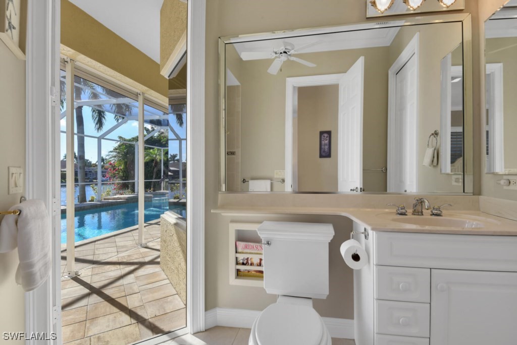 2810 Southwest 49th Terrace Cape Coral, FL 33914 - Photo 20 of 33 a en suite bathroom with a sink a mirror and a shower