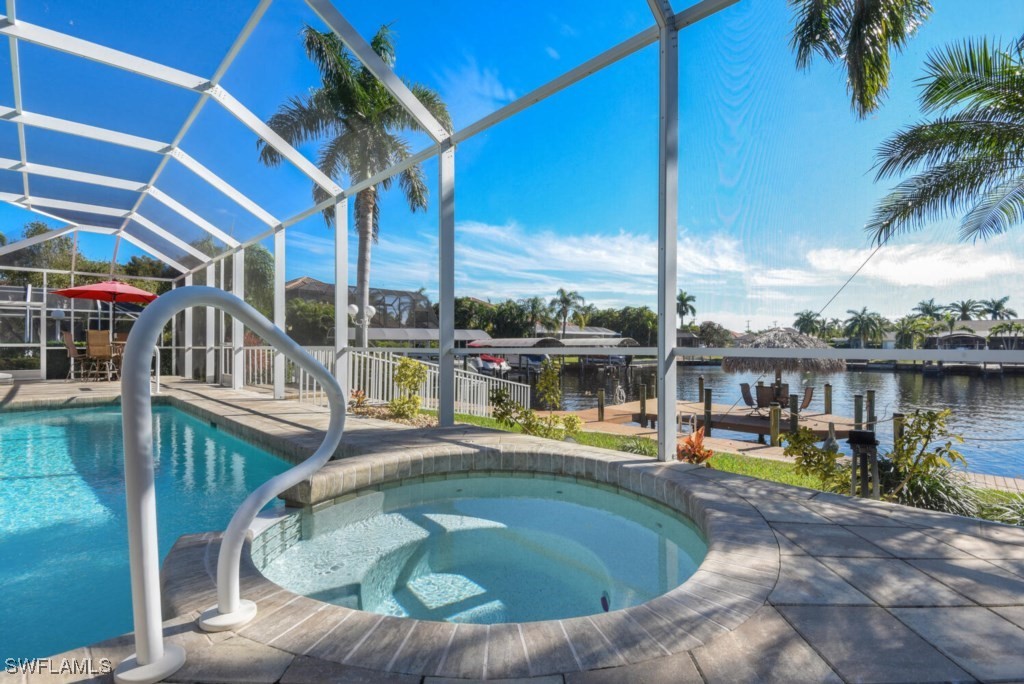 2810 Southwest 49th Terrace Cape Coral, FL 33914 - Photo 23 of 33 a view of a swimming pool with a lounge chairs