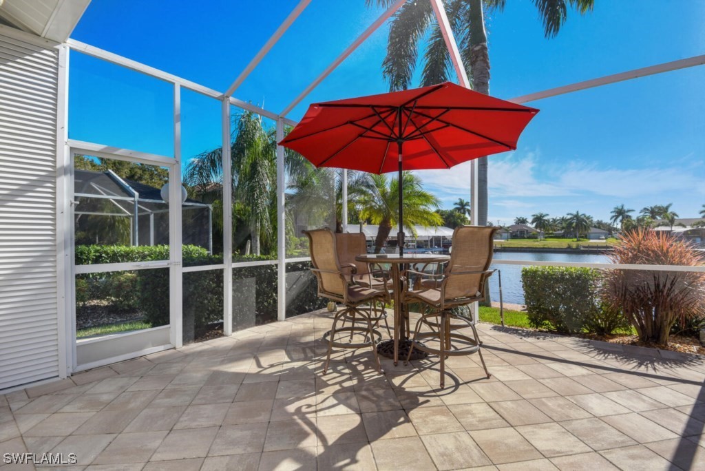 2810 Southwest 49th Terrace Cape Coral, FL 33914 - Photo 24 of 33 a patio with a yard table and chairs