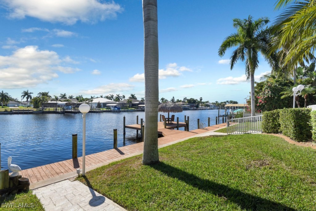 2810 Southwest 49th Terrace Cape Coral, FL 33914 - Photo 26 of 33 a view of a lake with a big yard and large trees