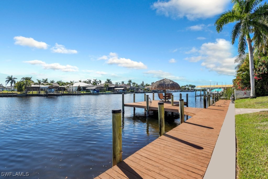 2810 Southwest 49th Terrace Cape Coral, FL 33914 - Photo 3 of 33 a view of a lake with boats and trees in the background