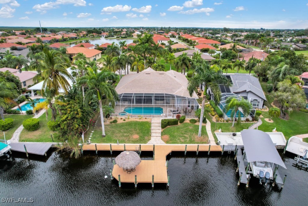 2810 Southwest 49th Terrace Cape Coral, FL 33914 - Photo 6 of 33 an aerial view of a house with swimming pool and outdoor seating