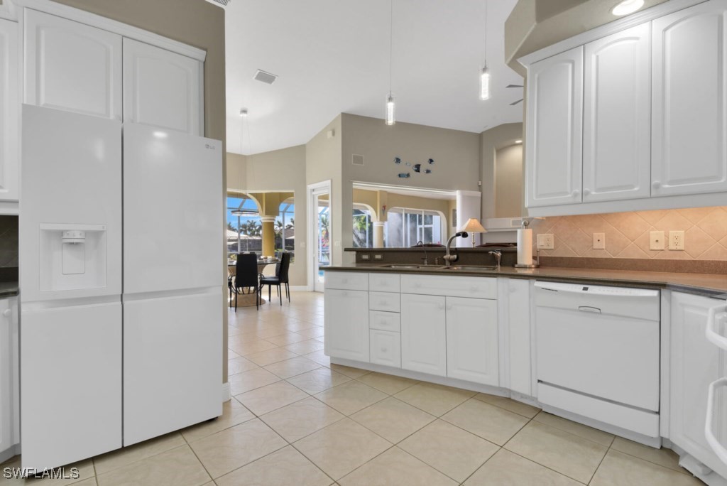 2810 Southwest 49th Terrace Cape Coral, FL 33914 - Photo 10 of 33 a kitchen with white cabinets and refrigerator