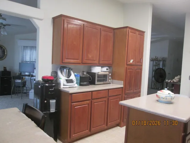 a kitchen with stainless steel appliances granite countertop a sink dishwasher and cabinets with wooden floor