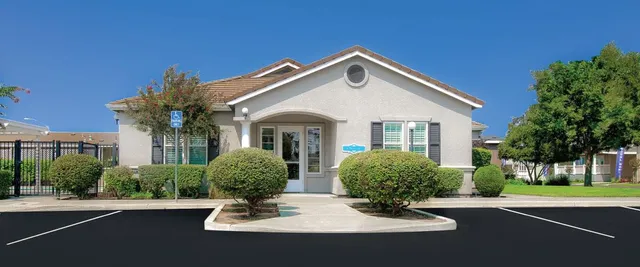 a view of a house with swimming pool and sitting area