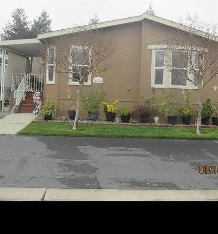 a view of a brick house with a yard