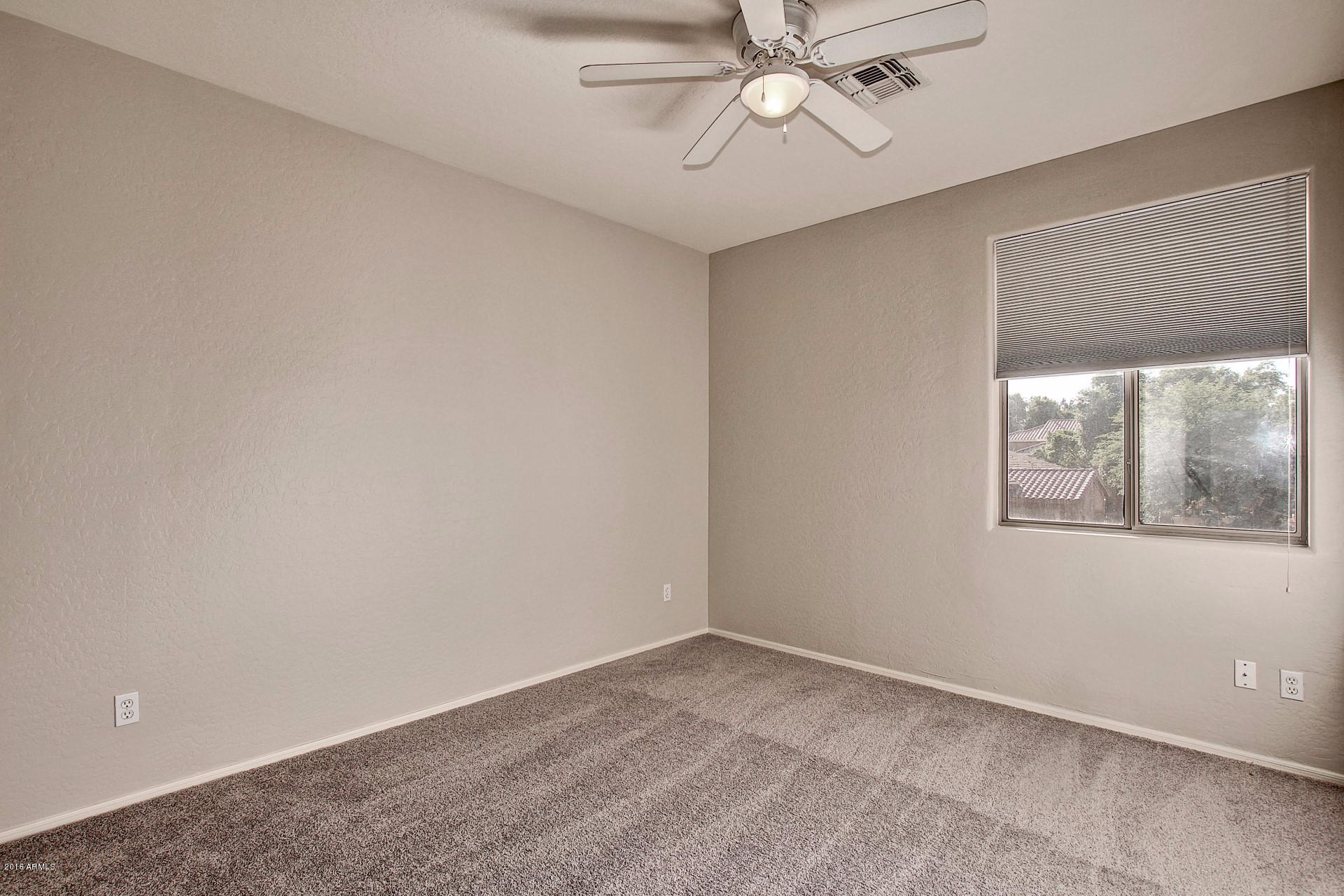 1360 East Harrison Street Gilbert, AZ 85295 - Photo 28 of 34 an empty room with a window and a fan