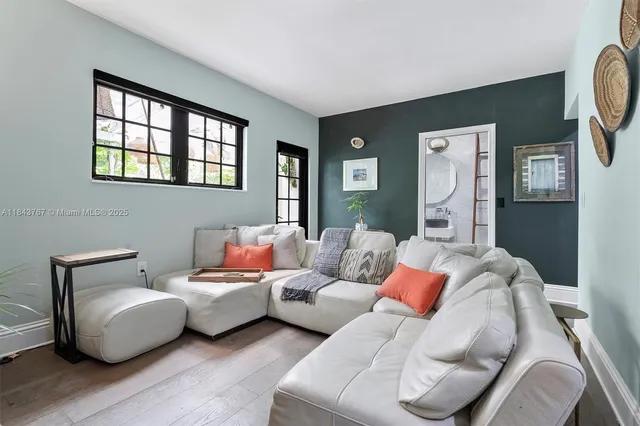 a living room with furniture a chandelier and a chandelier