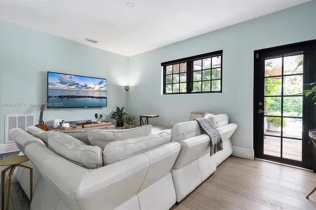 a living room with furniture and a chandelier