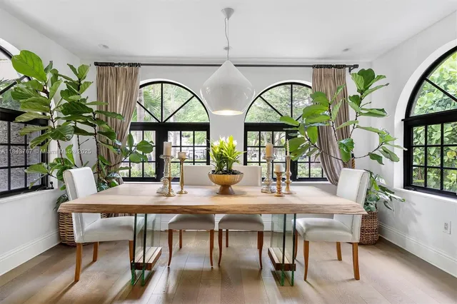 a kitchen that has a lot of cabinets a sink and wooden floor
