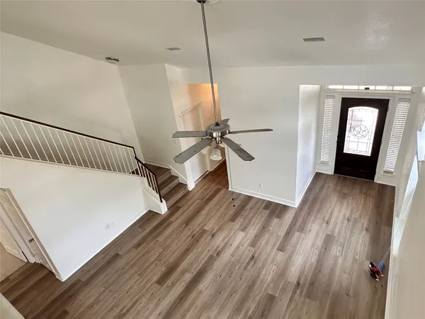 a view of a room with wooden floor and staircase