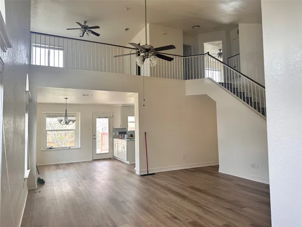 a view of a room with wooden floor and staircase