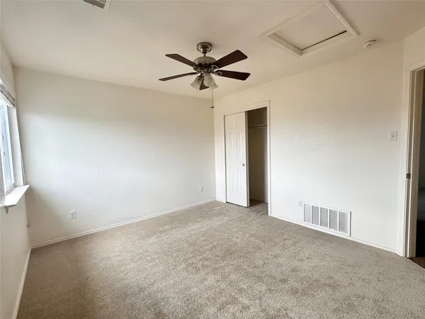 a view of a livingroom with a ceiling fan and window