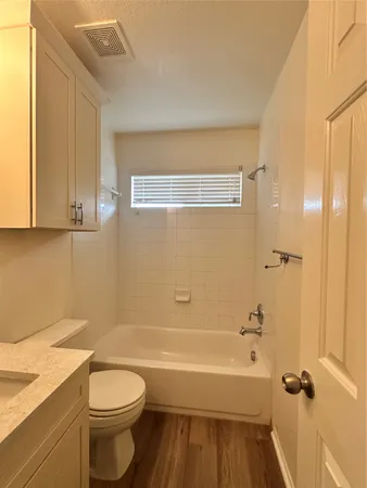 a bathroom with a sink a toilet and bathtub