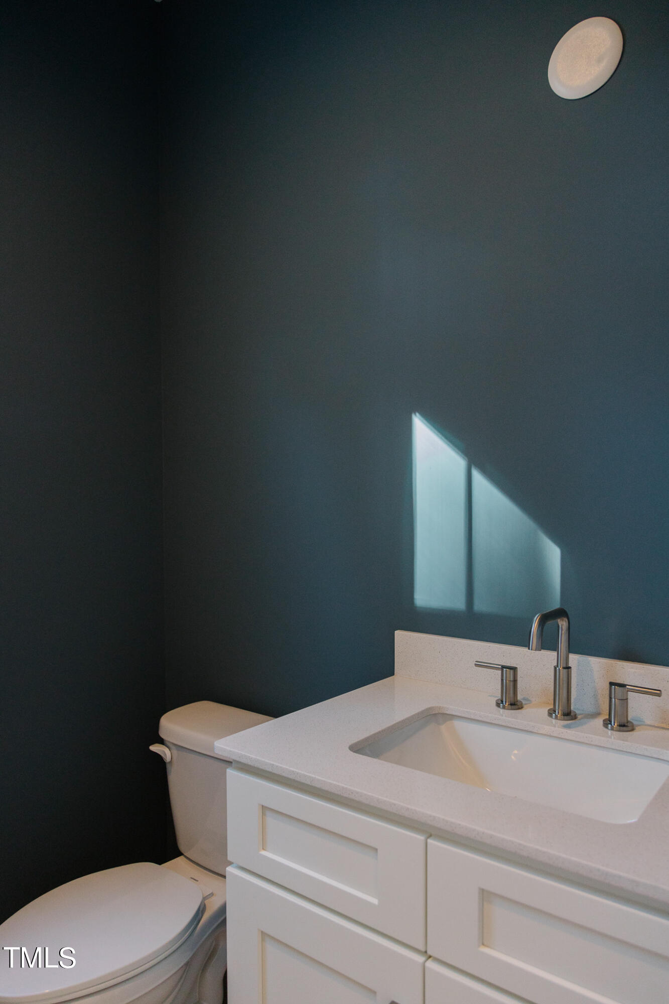 6425 Tanner Oak Lane Raleigh, NC 27613 - Photo 17 of 41 a bathroom with a toilet sink and mirror