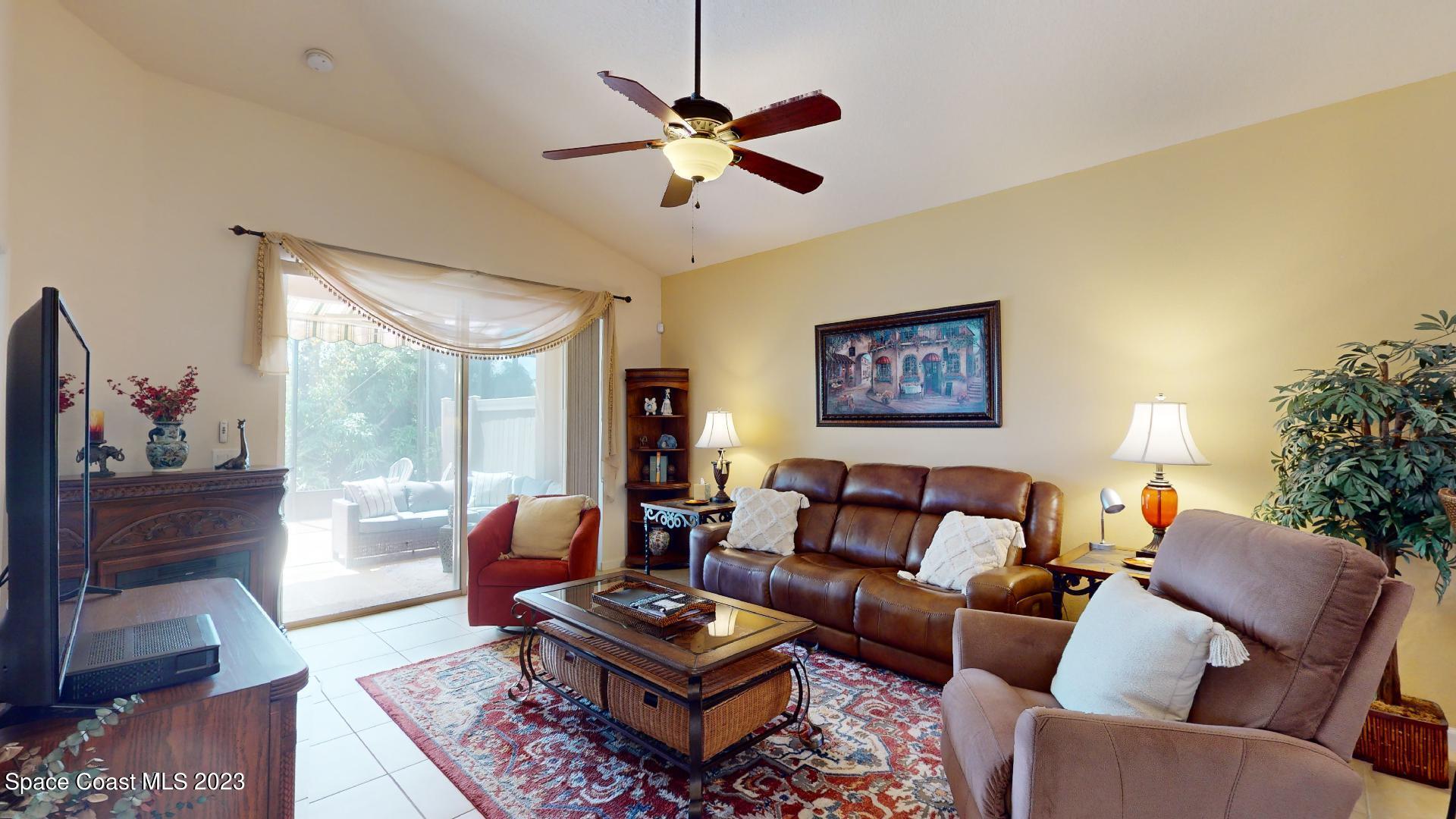 3242 Arden Circle Melbourne, FL 32934 - Photo 11 of 28 a living room with furniture a rug and a window