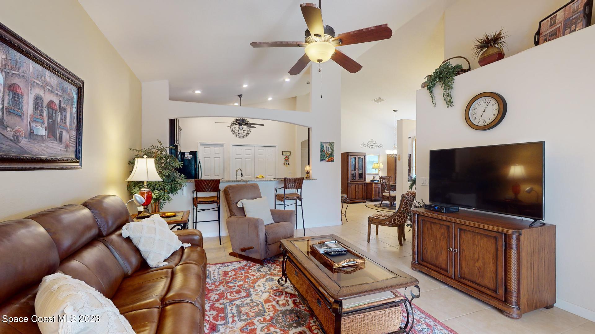 3242 Arden Circle Melbourne, FL 32934 - Photo 13 of 28 a living room with furniture and a flat screen tv
