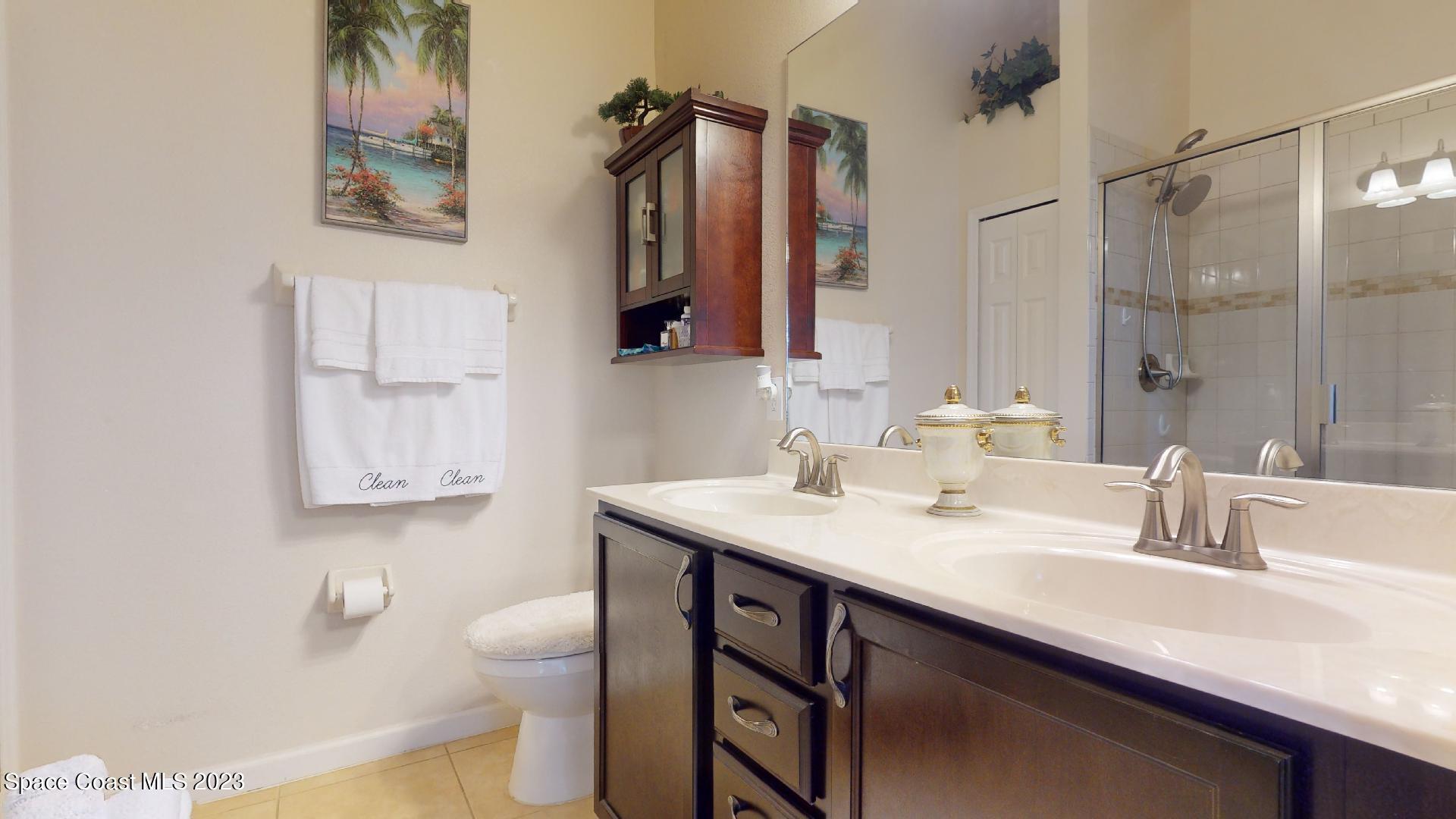 3242 Arden Circle Melbourne, FL 32934 - Photo 18 of 28 a bathroom with a sink vanity and toilet
