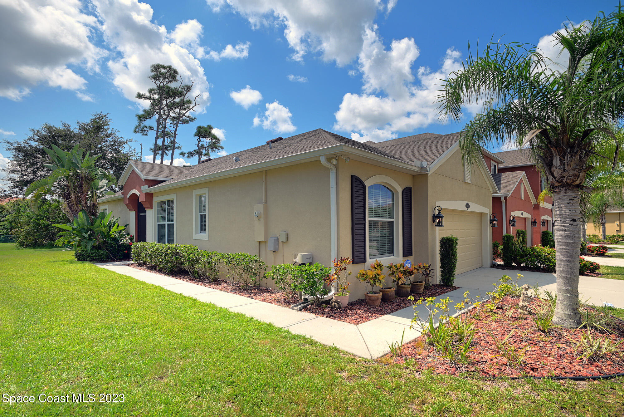 3242 Arden Circle Melbourne, FL 32934 - Photo 2 of 28 a front view of a house with garden