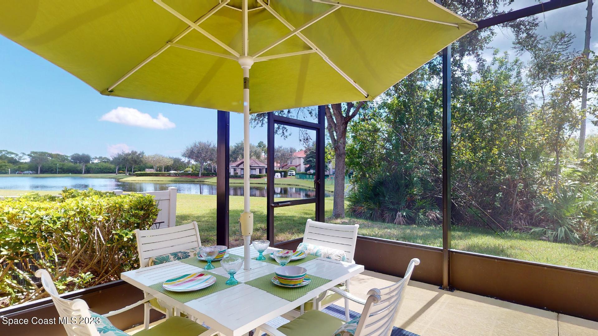 3242 Arden Circle Melbourne, FL 32934 - Photo 22 of 28 a view of a patio with couches under an umbrella
