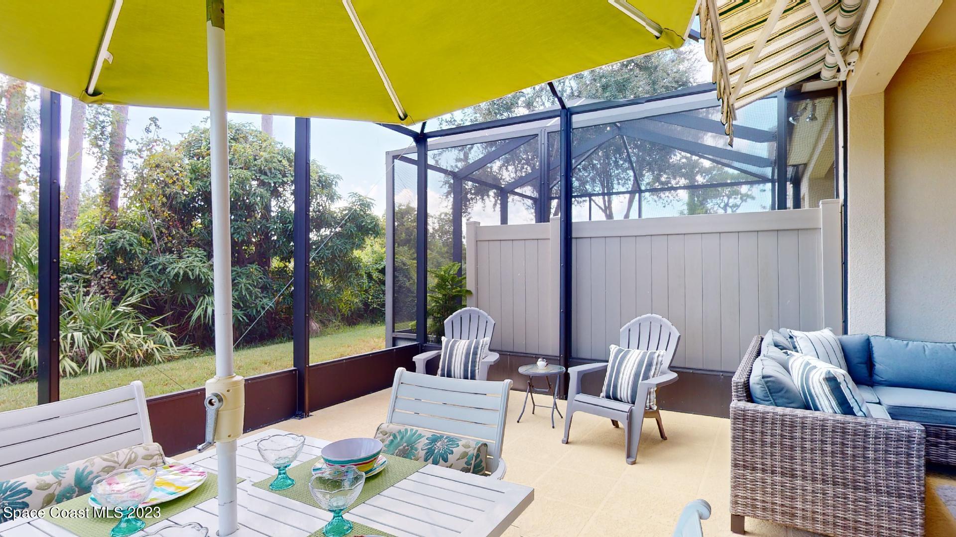 3242 Arden Circle Melbourne, FL 32934 - Photo 23 of 28 a view of a patio with a table and chairs under an umbrella
