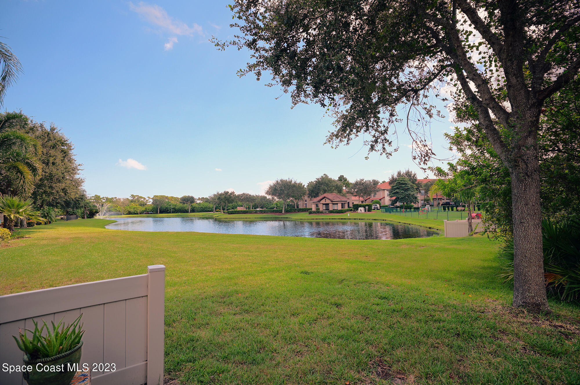 3242 Arden Circle Melbourne, FL 32934 - Photo 27 of 28 a view of a lake with houses in the back