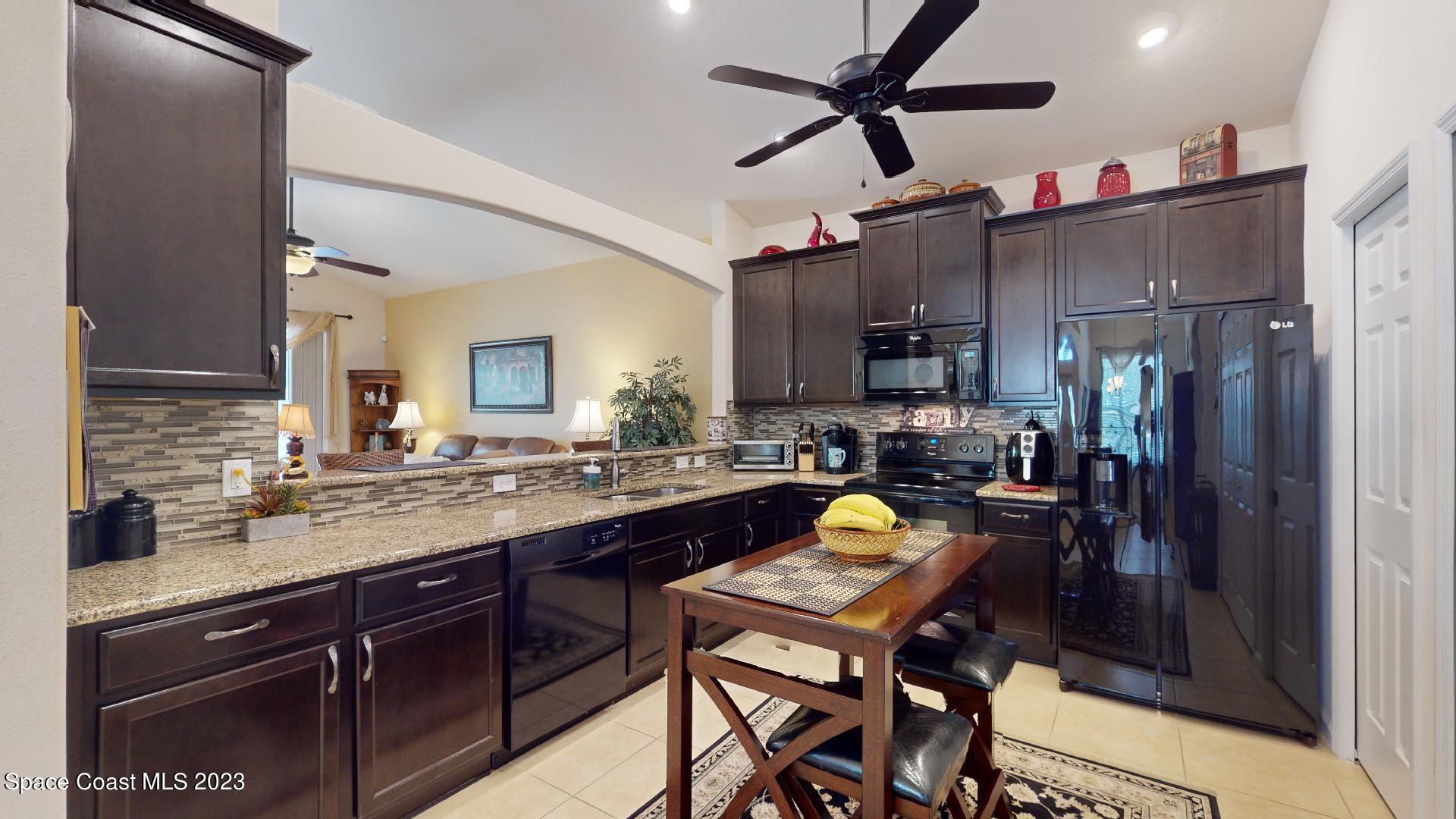 3242 Arden Circle Melbourne, FL 32934 - Photo 6 of 28 a kitchen with a sink appliances and cabinets