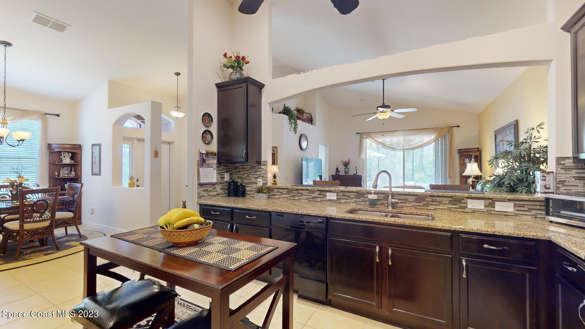 3242 Arden Circle Melbourne, FL 32934 - Photo 7 of 28 a kitchen with a sink cabinets and window