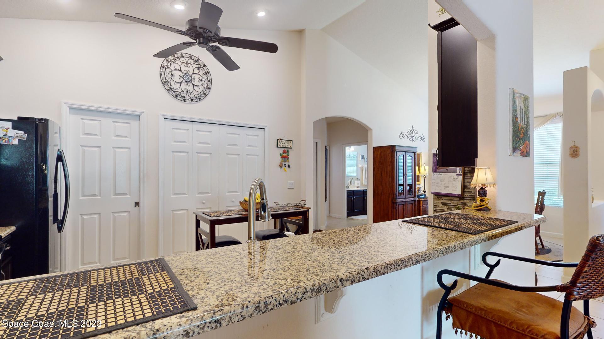 3242 Arden Circle Melbourne, FL 32934 - Photo 10 of 28 a view of a kitchen with kitchen island a counter top space and stainless steel appliances