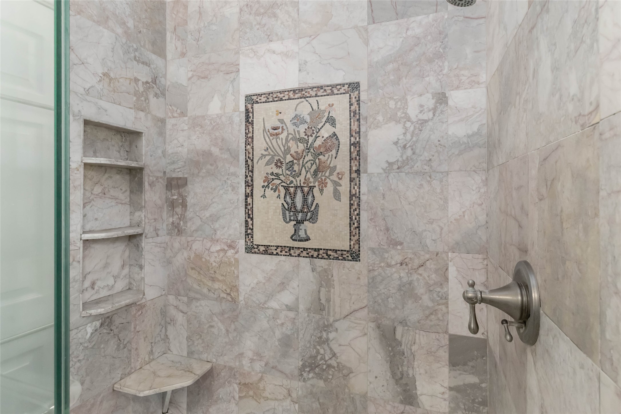 1208 Jeddo Road Rosanky, TX 78953 - Photo 14 of 40 A refined shower with marble tile walls and a built-in mosaic art piece provides a luxurious bathing experience.