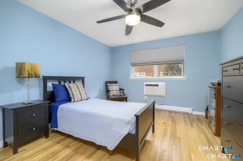637 Cove Road, Unit A3 Stamford, CT 06902 - Photo 5 of 7 a bedroom with a bed and a flat screen tv