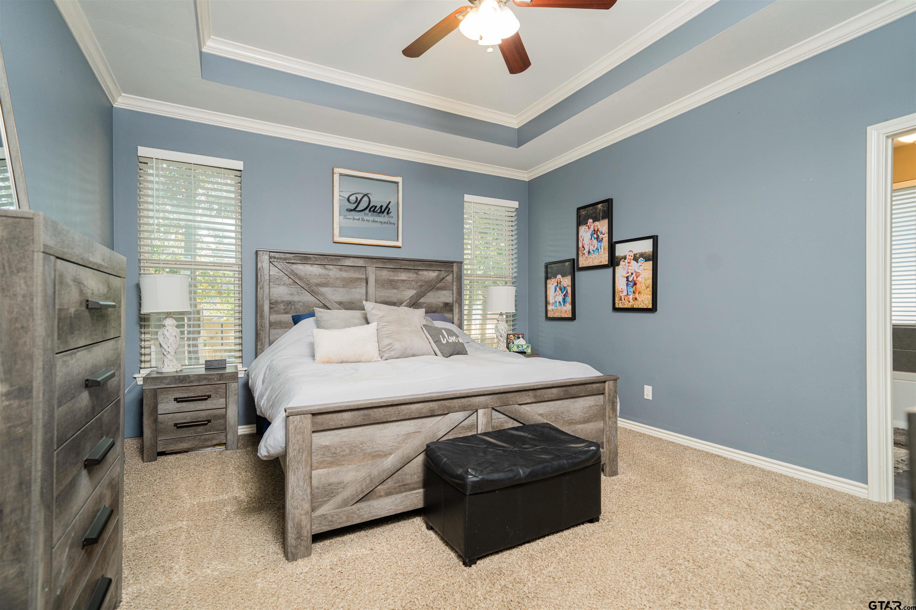 1001 Millstone Lane Chandler, TX 75758 - Photo 13 of 30 a bedroom with a bed and a chandelier