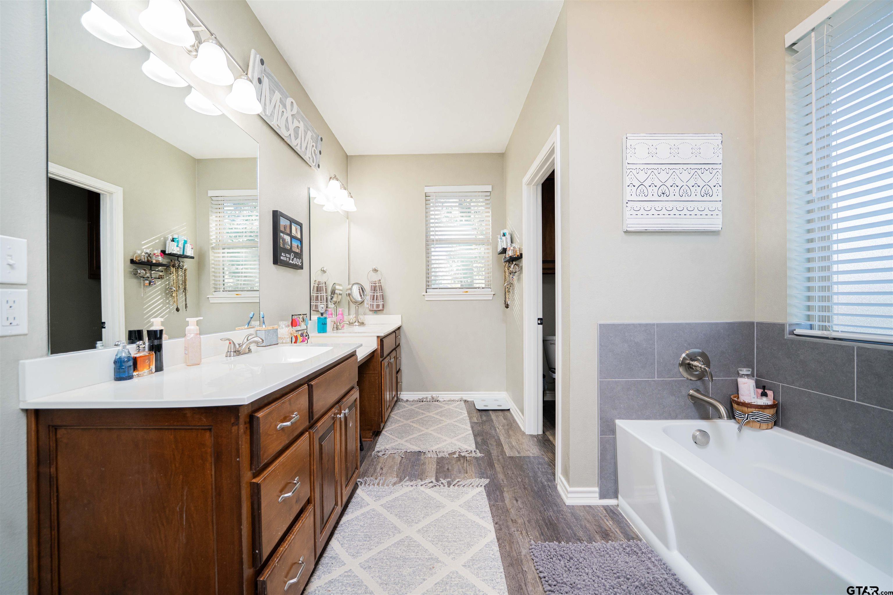 1001 Millstone Lane Chandler, TX 75758 - Photo 14 of 30 a bathroom with a tub sink and mirror