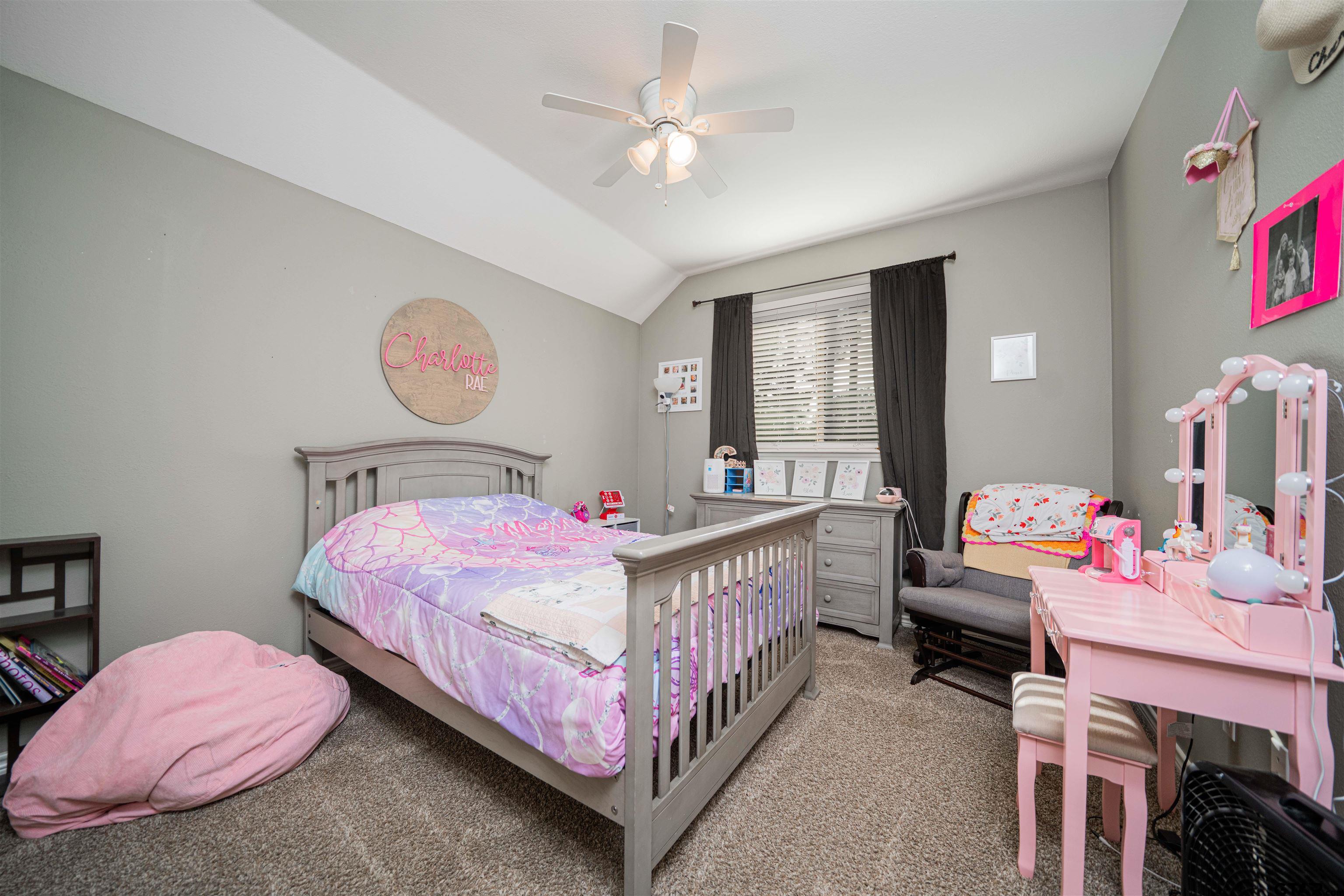 1001 Millstone Lane Chandler, TX 75758 - Photo 20 of 30 a bedroom with a bed and a chandelier