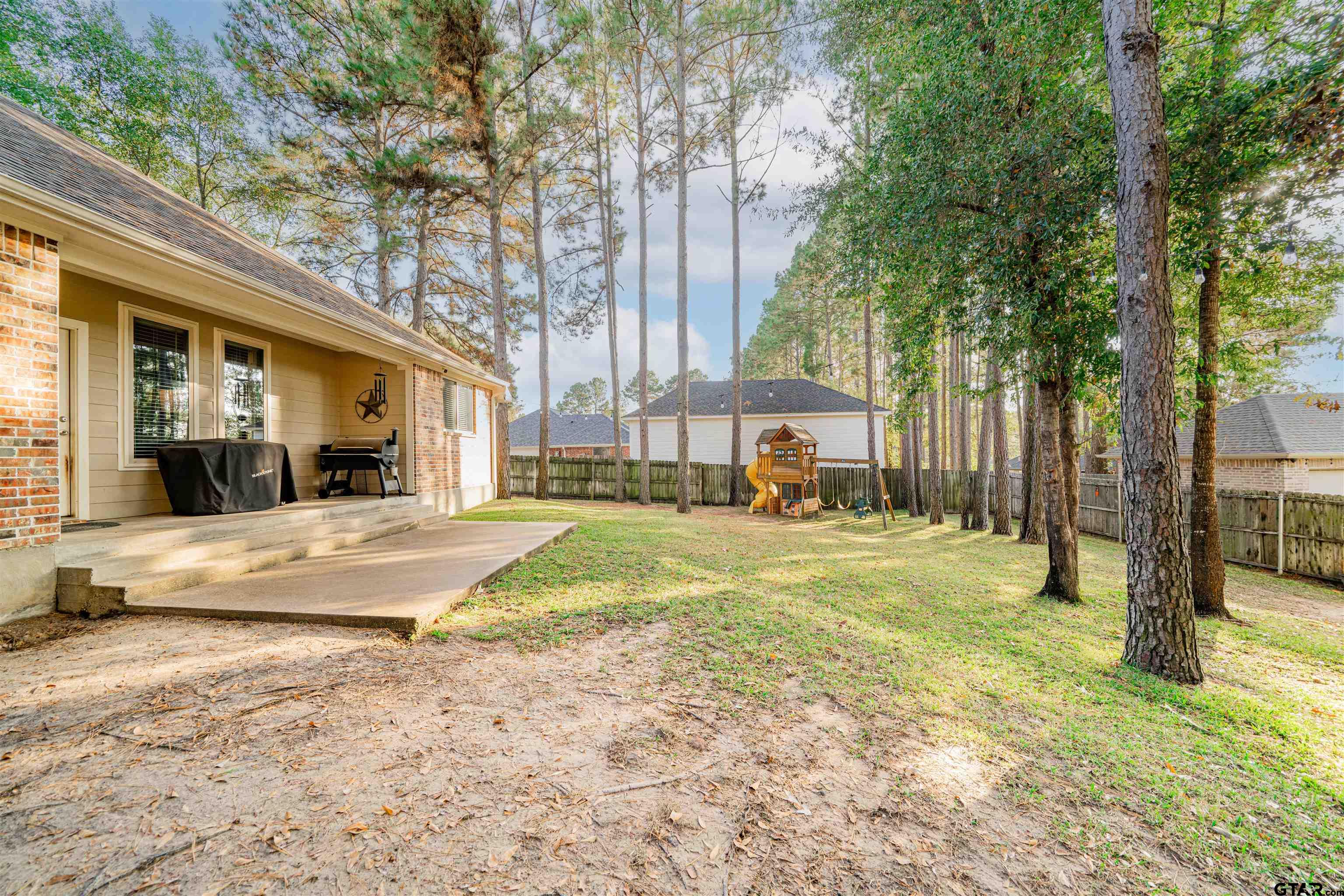 1001 Millstone Lane Chandler, TX 75758 - Photo 24 of 30 a view of a house with large trees and a big yard