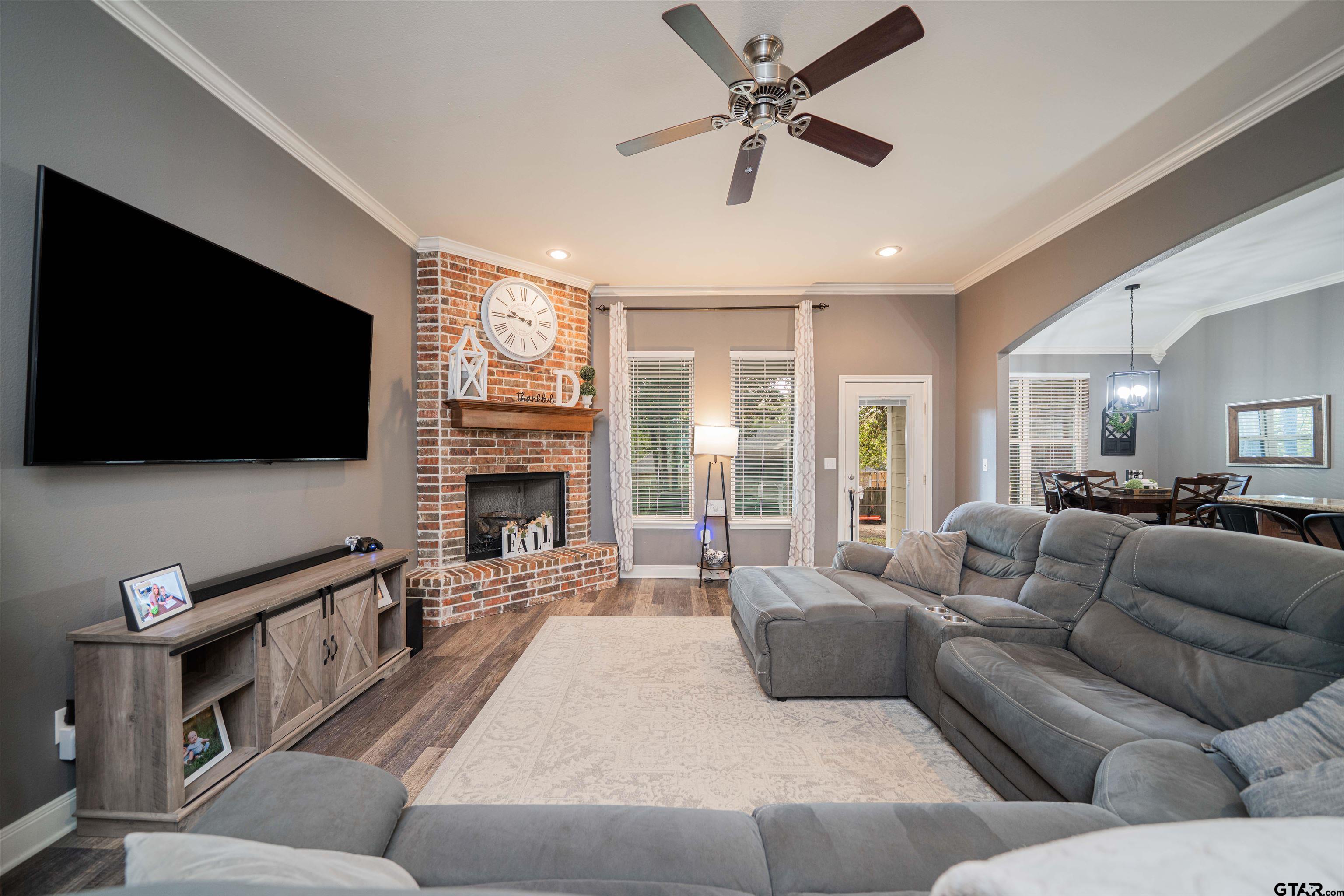 1001 Millstone Lane Chandler, TX 75758 - Photo 6 of 30 a living room with furniture a flat screen tv and a fireplace