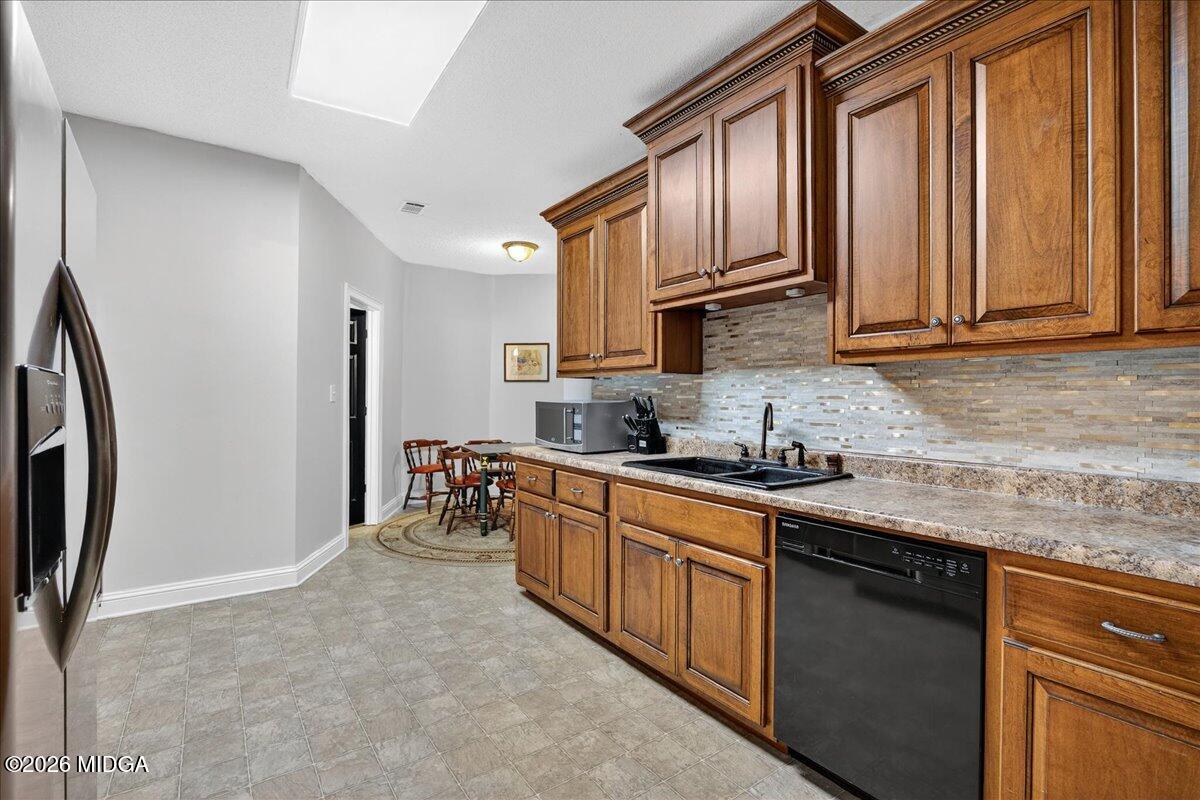 518 River Overlook Forsyth, GA 31029 - Photo 51 of 96 a kitchen with stainless steel appliances granite countertop a refrigerator sink and cabinets