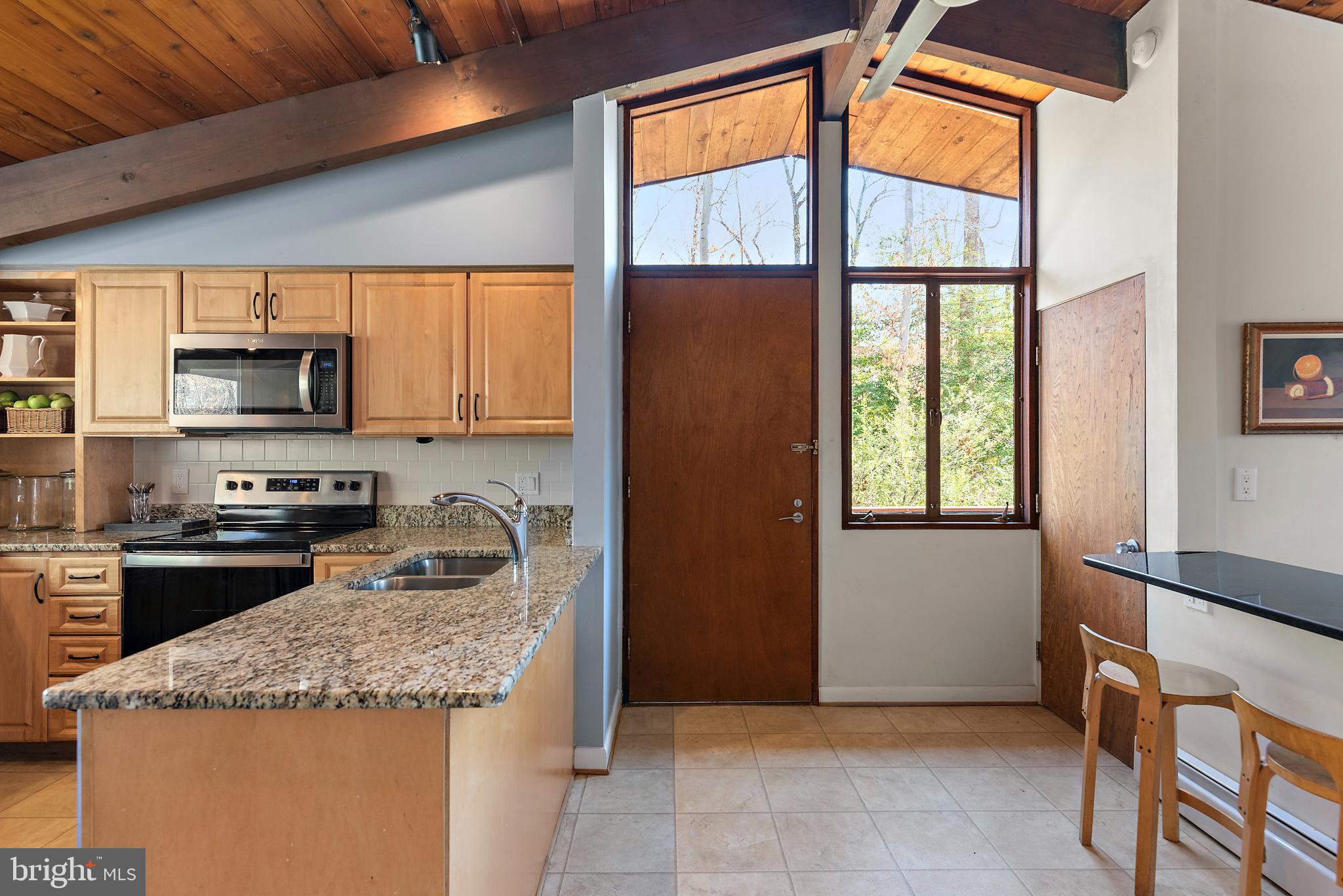 519 Epping Forest Road Annapolis, MD 21401 - Photo 29 of 73 a kitchen with granite countertop a sink stainless steel appliances a counter top space and a window