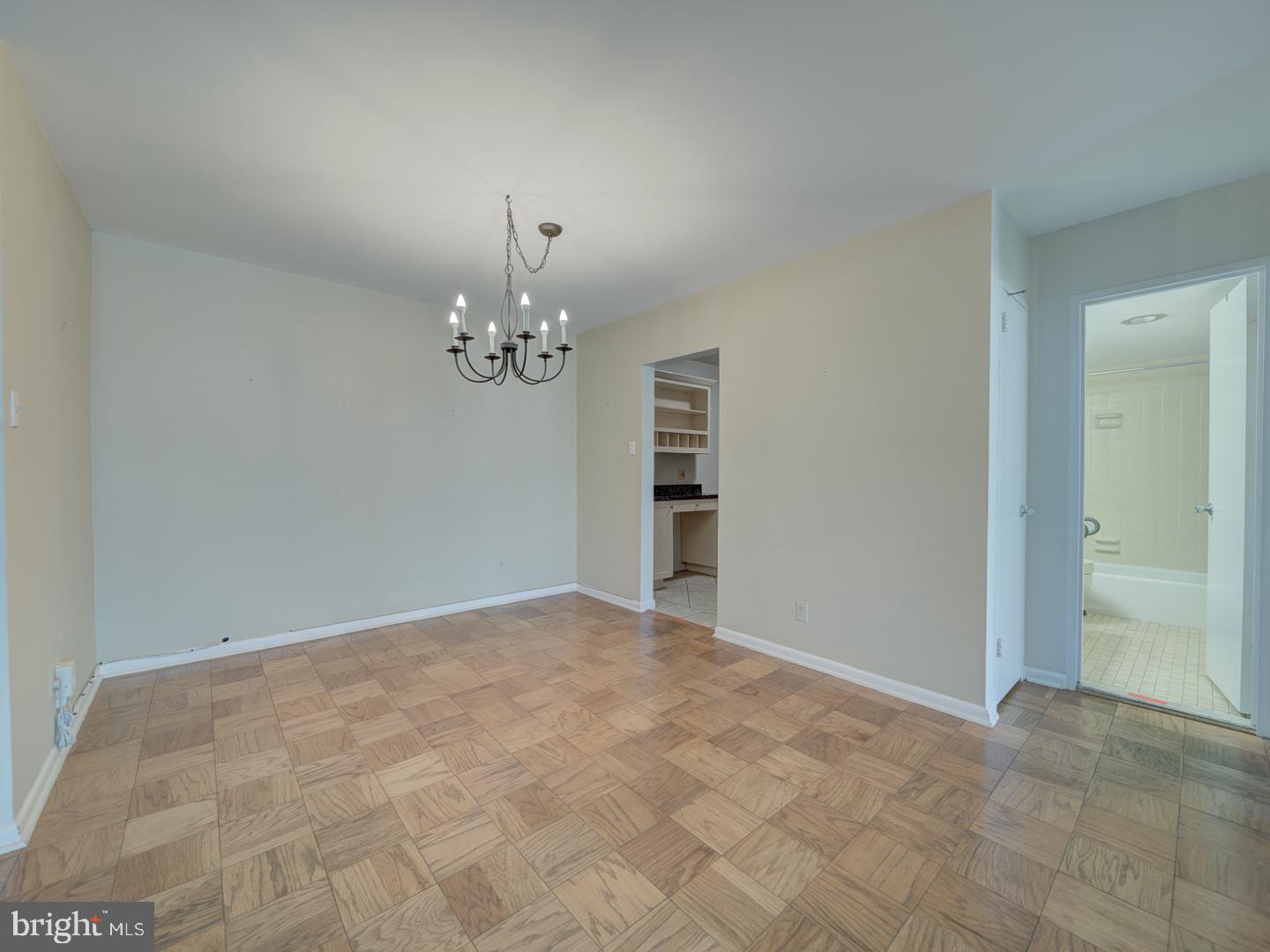 5101 River Road, Unit 411 Bethesda, MD 20816 - Photo 13 of 26 a view of a chandelier in big room and chandelier