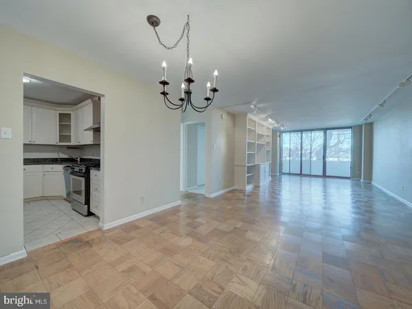 a kitchen with granite countertop a sink stove and refrigerator