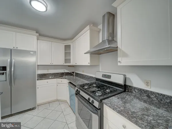 a kitchen with a stove and a refrigerator
