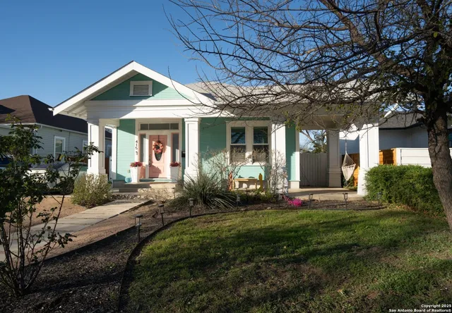 a front view of a house with a yard table and chairs