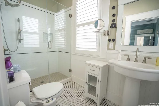 a bathroom with a sink toilet and shower